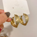 Twisted Ridged Hoop Earrings with Sculpted Polished Metal Details view 2