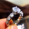 Round Center Stone Eternity Band Ring With Pavé Setting view 1