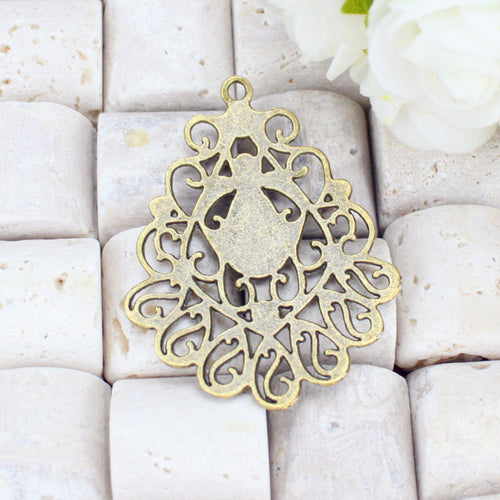 Closer view of the ornate teardrop chandelier component surface and openwork details