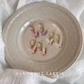 Gold Huggie Hoop Earrings Pink White Butterfly Charms view 1