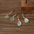 Gold Tone Shell Pattern Teardrop Hook Earrings In Black And White view 1