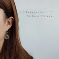 Gold Tone Shell Pattern Teardrop Hook Earrings In Black And White view 4