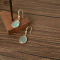 Gold Tone Shell Pattern Teardrop Hook Earrings In Black And White view 2