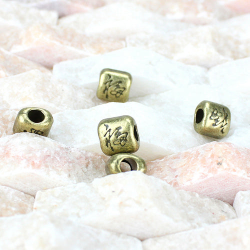 Square fortune character spacer bead components displayed in multiple metal finishes