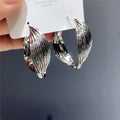 Twisted Ridged Hoop Earrings with Sculpted Polished Metal Details view 7