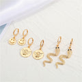 Gold Tone Smiley Angel and Snake Huggie Drop Earrings in Three Designs view 1