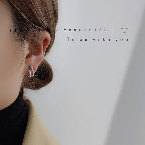 Gold geometric multi-wear earring worn on ear