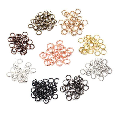 Metallic jump ring jewelry findings arranged on a light background