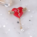 Hands Holding Broken Red Heart Brooch With Pearl Drop view 4
