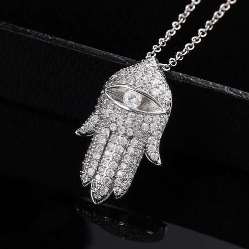 Silver pave Hamsa hand eye pendant on black background