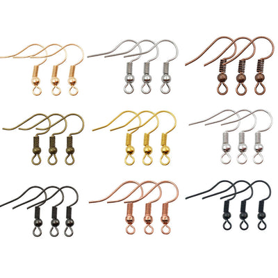 Metallic earring hook jewelry findings arranged on a light background
