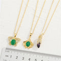 Gold Tone Butterfly, Ginkgo Leaf and Feather Pendant Necklaces view 2