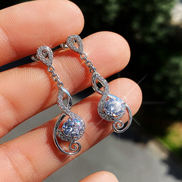 Silver Tone Swirl Drop Earrings with Clear Teardrop Stones