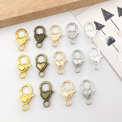 Metallic lobster clasp jewelry findings arranged on a light background
