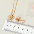 Gold Tone Crystal Butterfly Pendant Necklace and Huggie Earrings view 2
