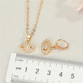 Gold Tone Crystal Evil Eye Pendant Necklace and Huggie Earrings view 5