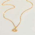 Gold Tone Crystal Evil Eye Pendant Necklace and Huggie Earrings view 2