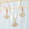 Gold Tone Crystal Evil Eye Pendant Necklace and Huggie Earrings view 1