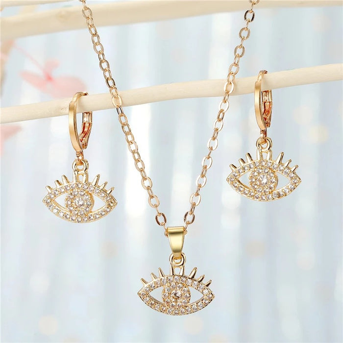 Gold Tone Crystal Evil Eye Pendant Necklace and Huggie Earrings