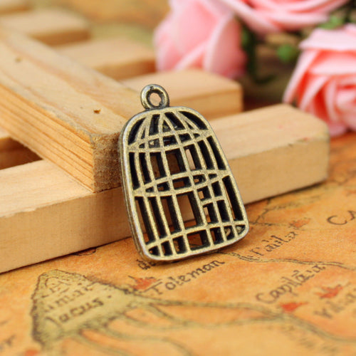 Alternate view of the geometric birdcage charm showing its raised and recessed details
