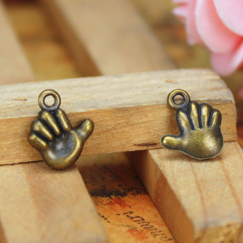 Alternate view of the raised hand charm showing its raised and recessed details
