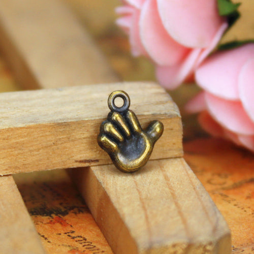 Gallery view of the raised hand charm showing its overall shape