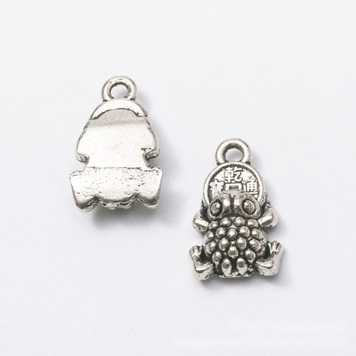 Angled detail views of money toad charms