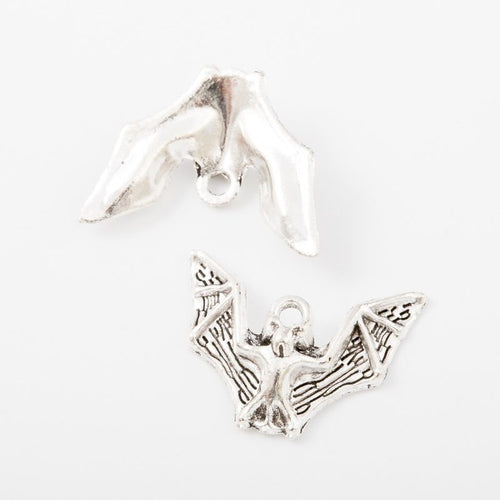 Close product view of the spread wing bat metal charm in two antique finishes