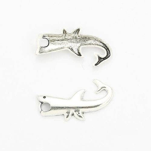 Front and reverse views of the curved shark charm