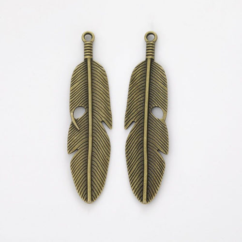 Close view of the front details on long feather charm pendants