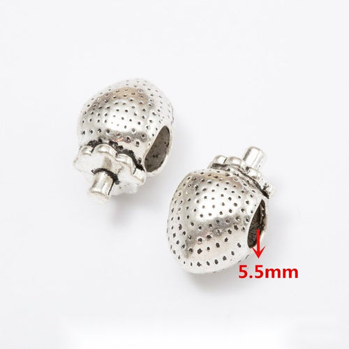 Front and reverse details of nature pattern beads on a white background