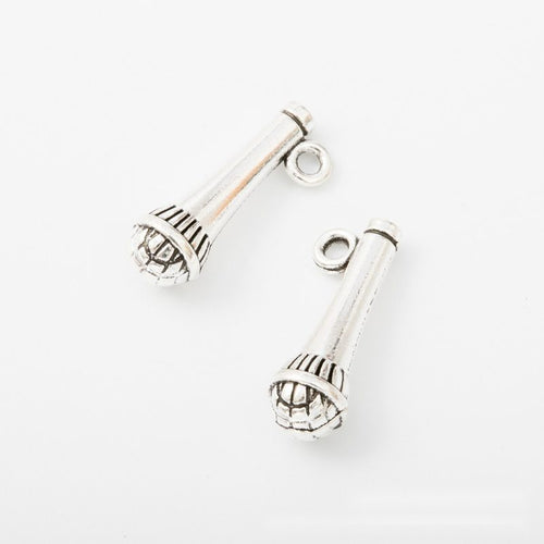 Close view showing the front and reverse details of the handheld microphone charm
