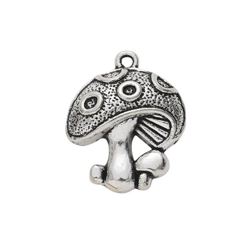 Close front and reverse view of the metal mushroom charm