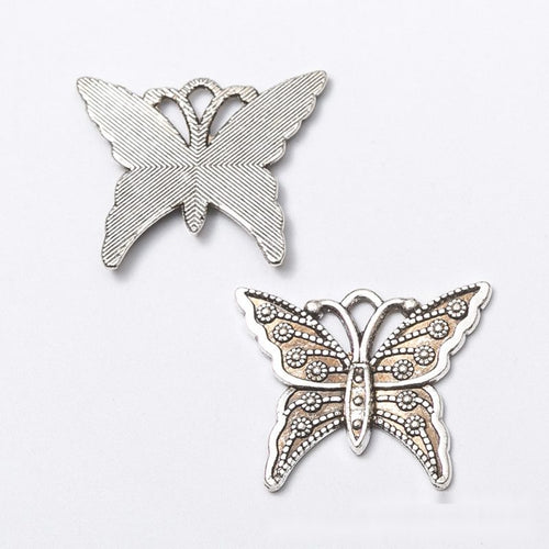 Close view of the a butterfly with open wings, dotted borders, and scroll details