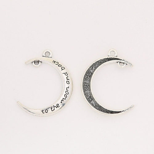 Close view of the engraved crescent moon showing a slim crescent with tiny engraved lettering