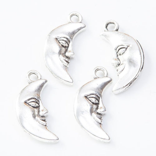 Close view of the moon face charm showing its raised front pattern