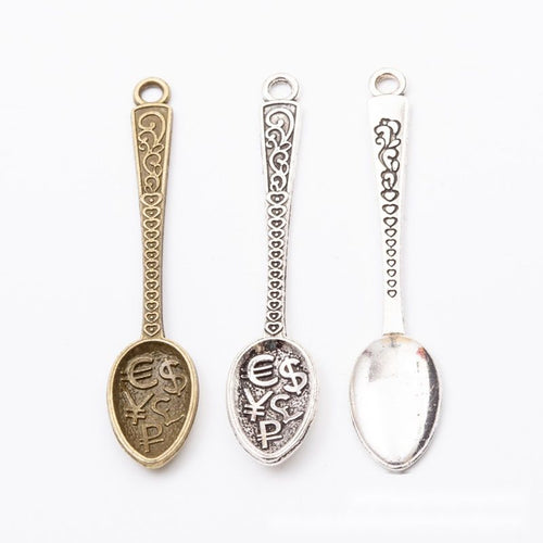 Additional front and reverse view of the ornate spoon charm