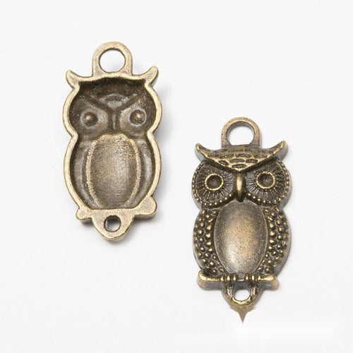 Close product view of the owl oval bezel tray connector in two antique finishes