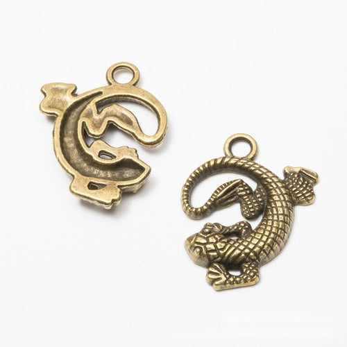 Curled lizard metal component, front and reverse detail on white