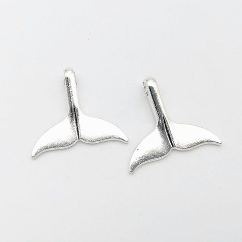 Whale tail charm shown in front and reverse details
