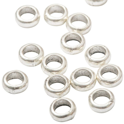 Close front view showing the shape and recessed details of the smooth large hole spacer beads