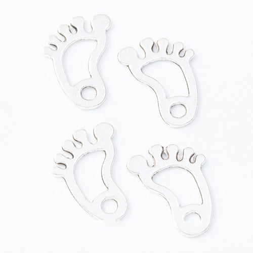 Front and reverse details of footprint charms on a white background