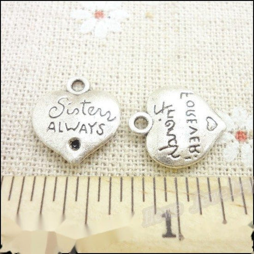 Front and reverse views of the sister always heart metal charm in antique silver finish