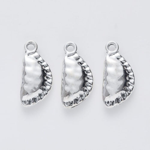 Close front and reverse view of the metal dumpling charm