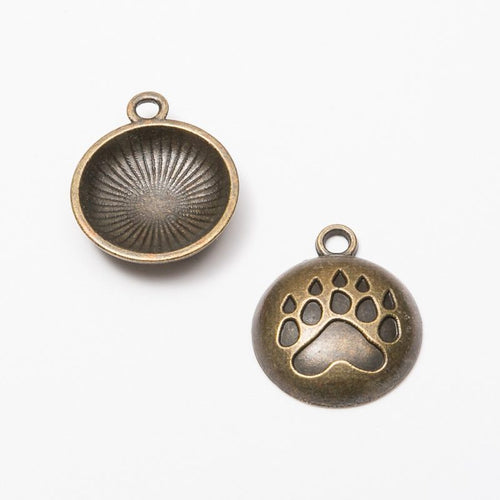 Paw Print Medallion metal piece showing front-facing surface and relief detail