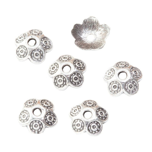 Rounded flower bead cap with circular petal motifs shown in front detail view
