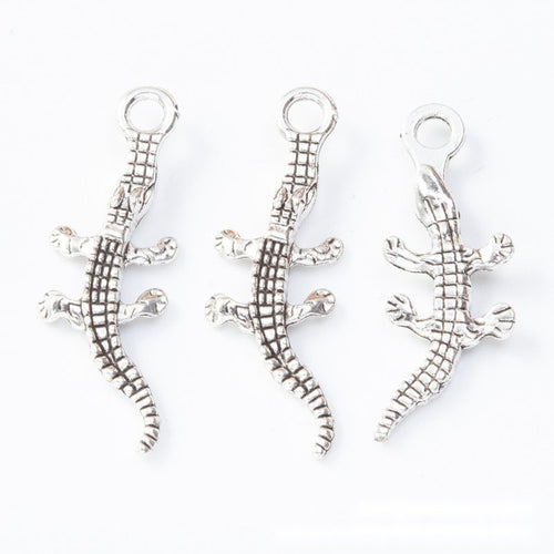 Front and reverse details of crocodile charms on a white background