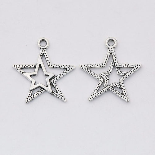Close front and reverse view of the metal layered open-star charm