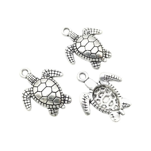 Front and reverse views of the sea turtle charm