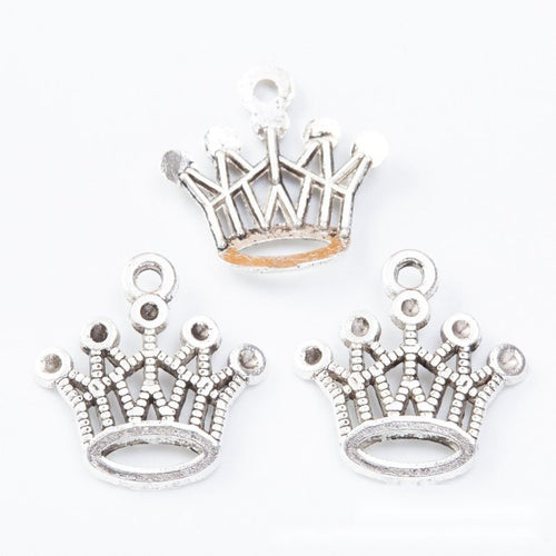 Close view showing the front and reverse details of the open crown charm